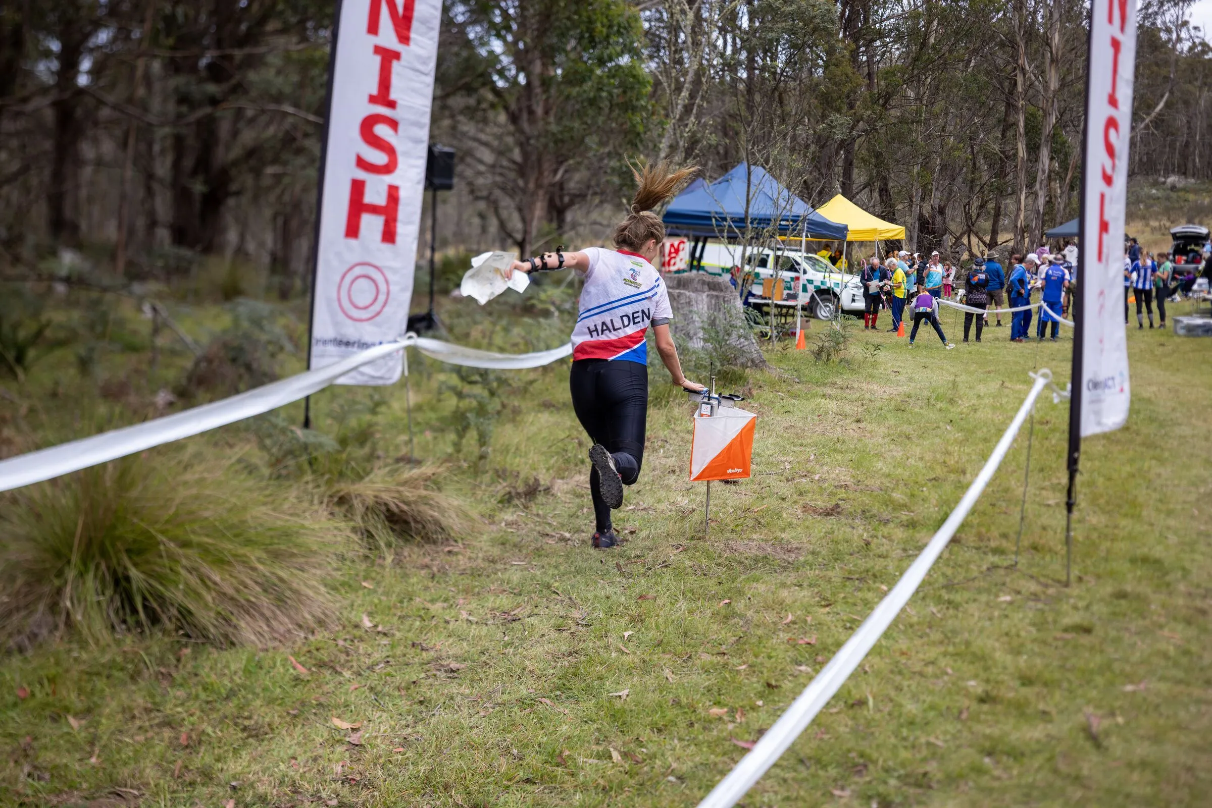 A competitor running down the finish chute at an orienteering event