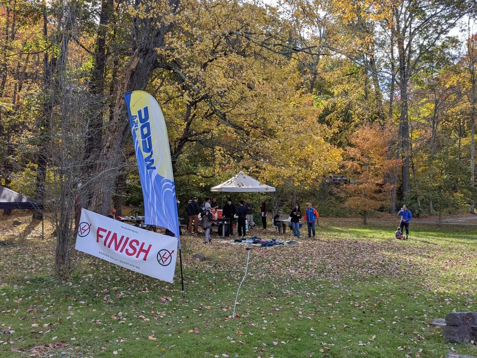 The finish banner and arena tent at Blue Mountain Reservation under autumn trees