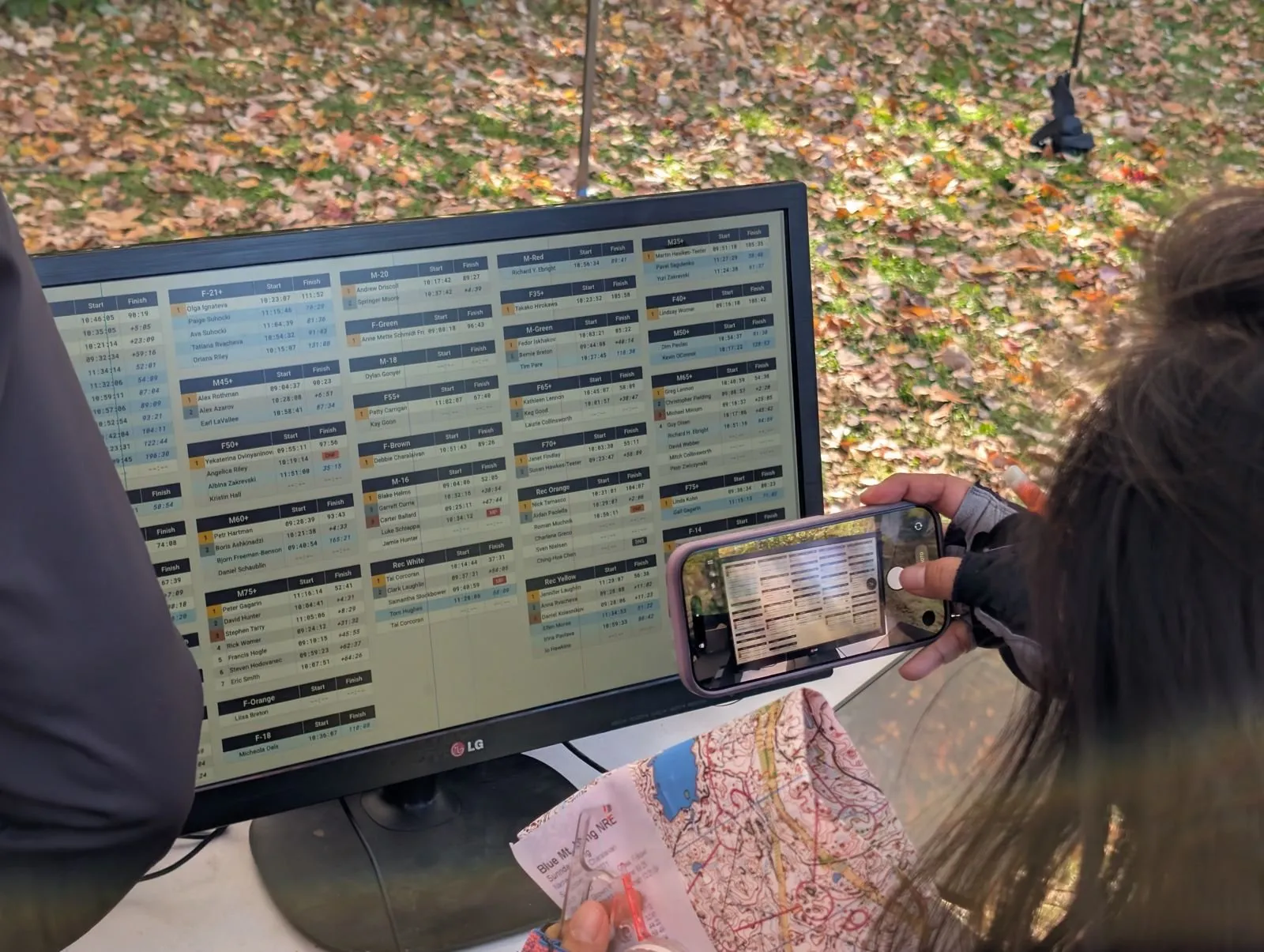 A runner photographing the results screen with a phone